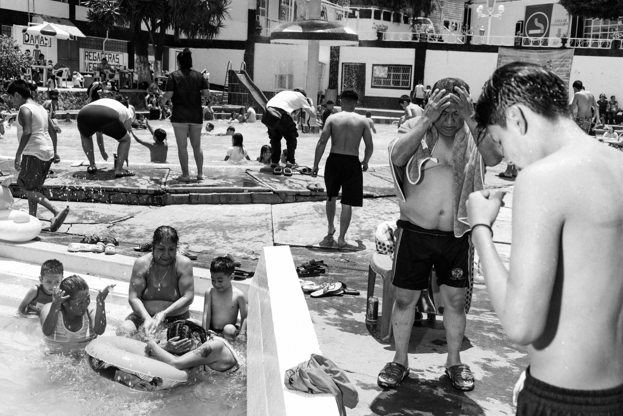 A mother enjoys the swimming pool with her children at Balneario Elba, May 26, 2024.